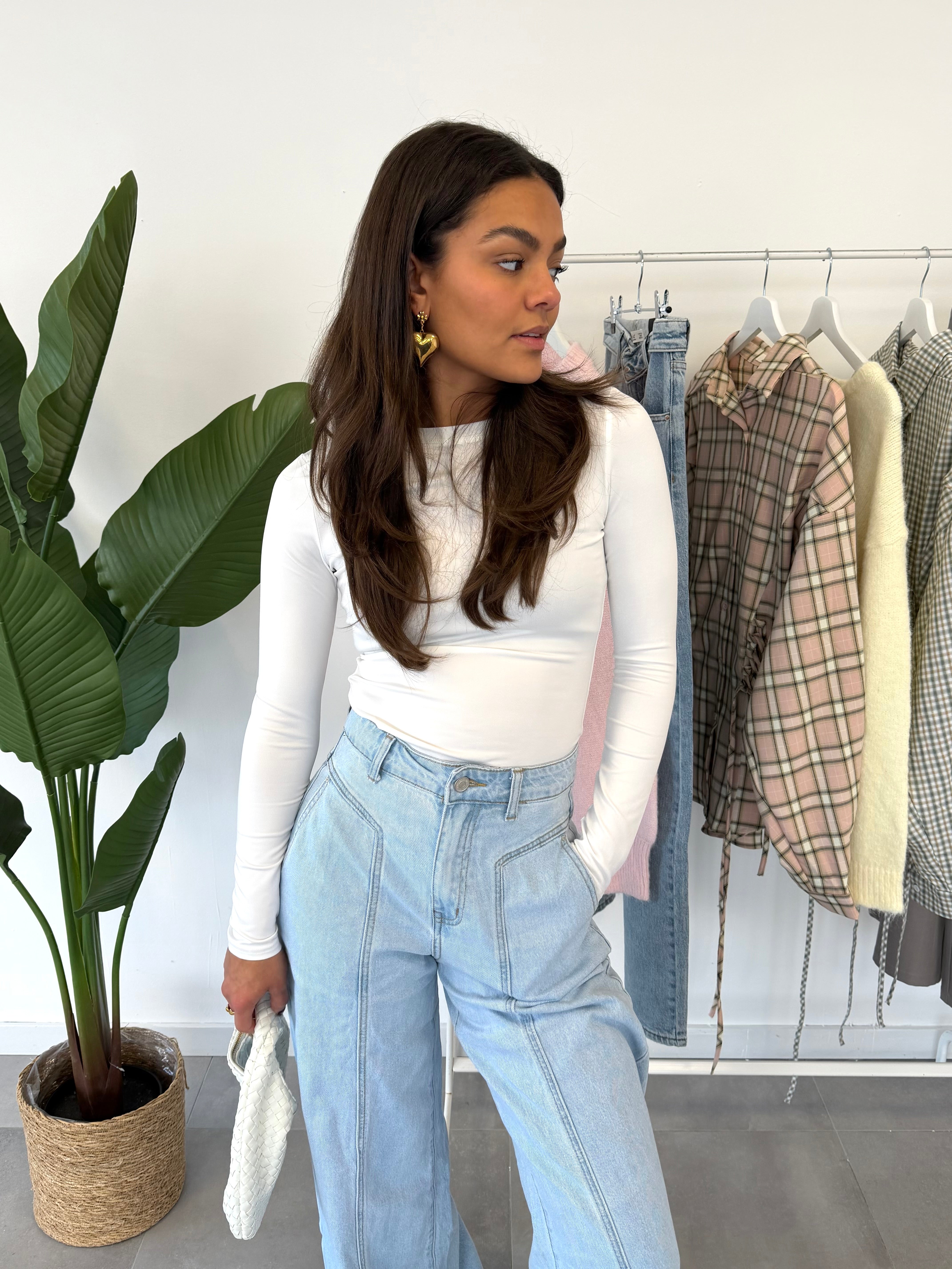 Fiora jeans – wijdvallende broek met subtiele streepdessin als detail, gecombineerd met een witte longsleeve, vooraanzicht